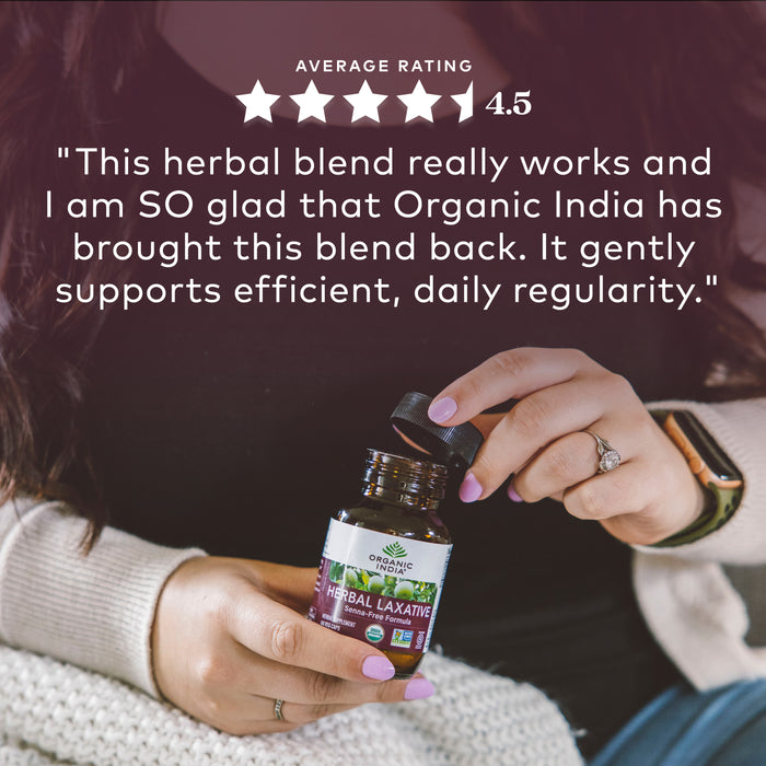 Woman holding organic herbal laxative capsules in glass jar with review about it helping with regularity.