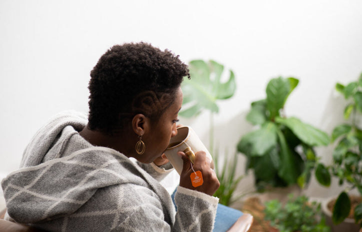 a woman drinking herbal tea