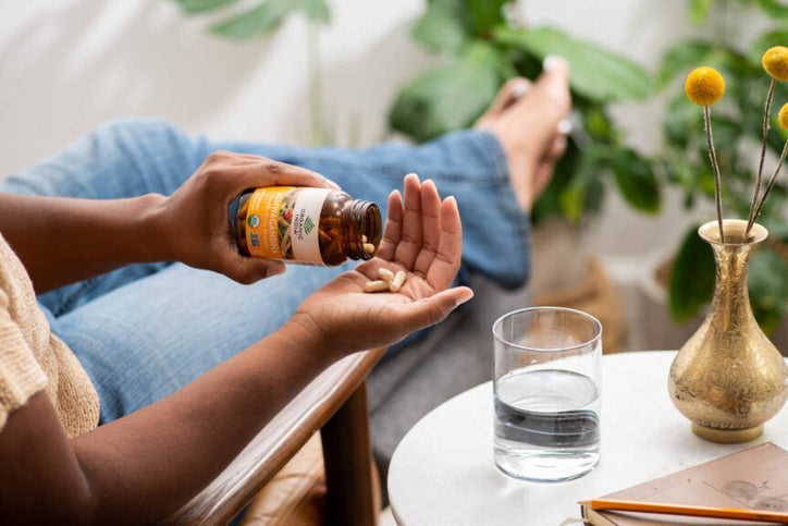 woman taking ashwagandha capsules supplement