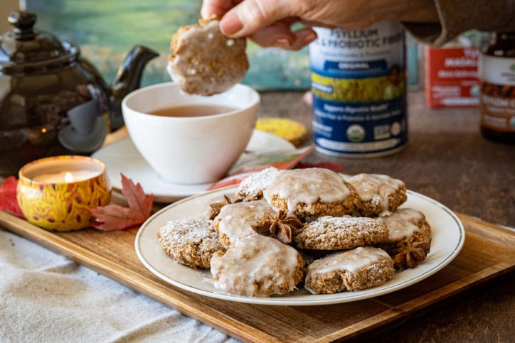 Chai spice cookies on white plate and dipped in tea