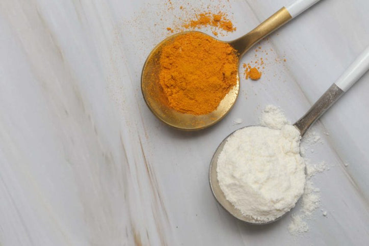 collagen and turmeric on their own spoons on marble countertop