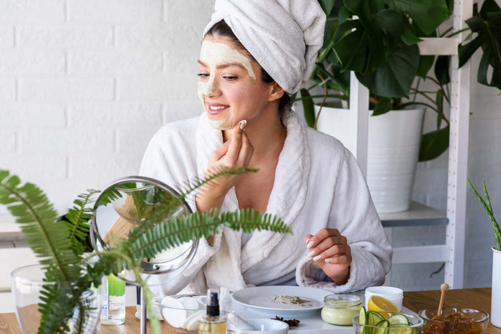 woman putting gotu kola for skin on her face as part of her beauty regimen 