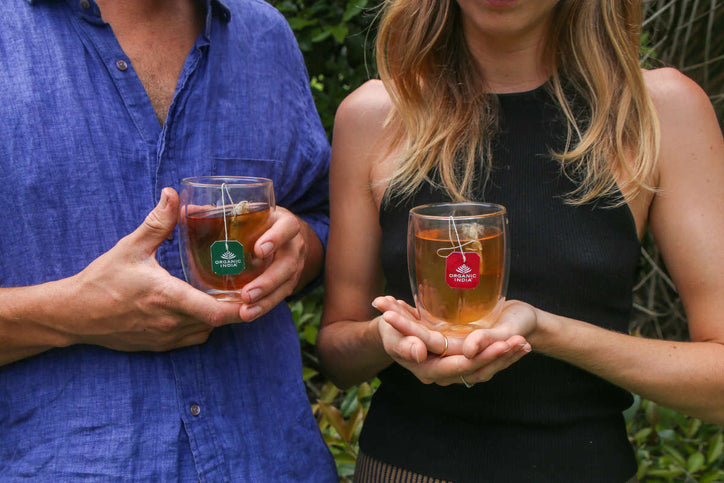 a man and a woman outside drinking tulsi tea for stress relief