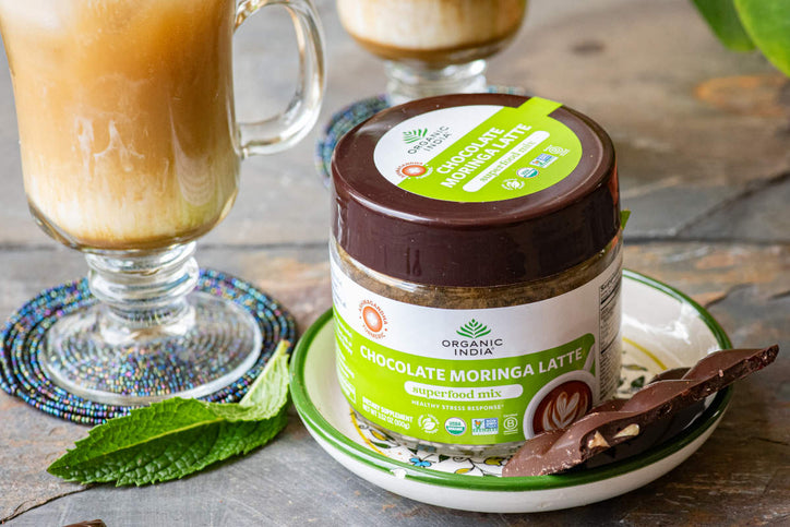 iced chocolate moringa latte on wood table