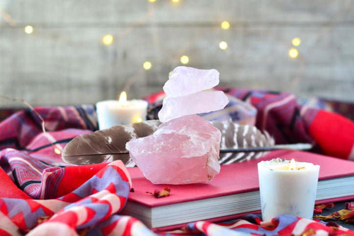 pink crystal with candles on a pink book