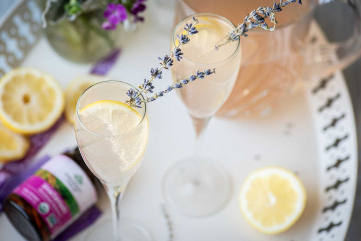Lavender lemonade with shatavari in flute glasses with lavender garnish