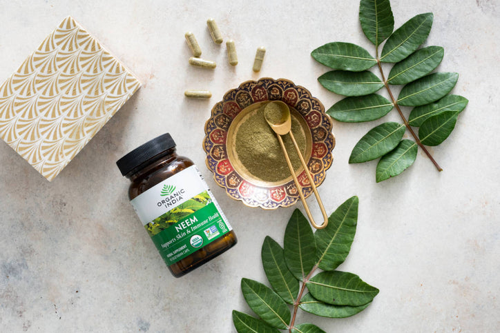 neem jar and loose capsules on marble table