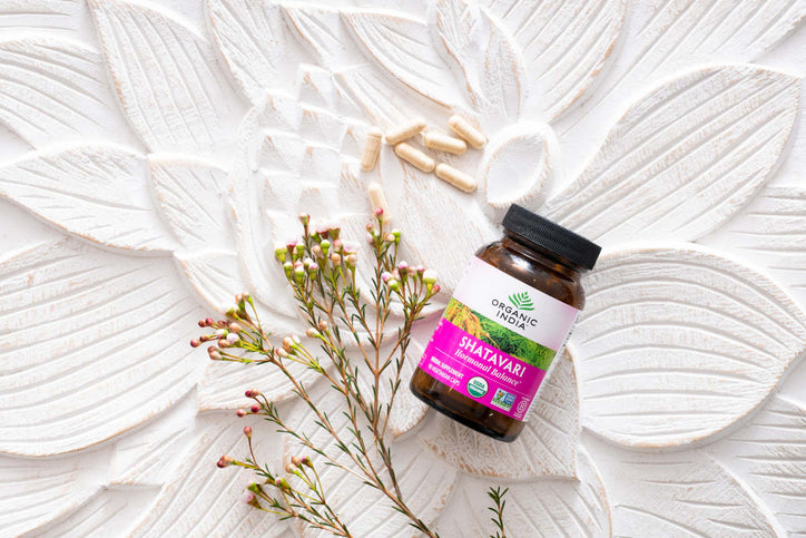 shatavari glass amber jar and capsules on lotus imprint wood table