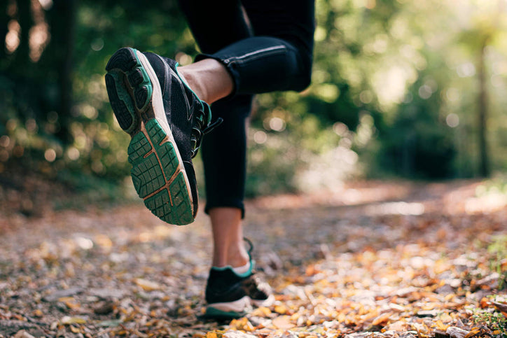 woman running on forest trail